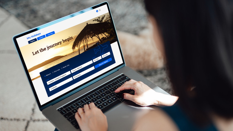 A woman booking vacation on laptop