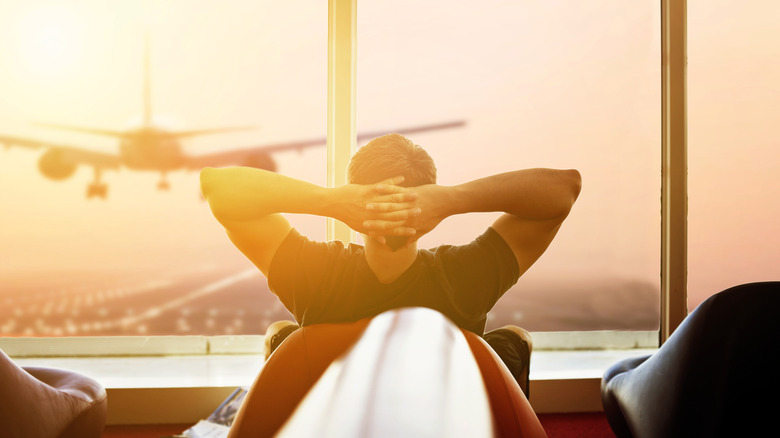 A male traveler relaxing during an extended layover