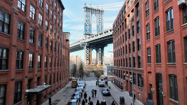 Brooklyn Bridge visible between two buildings in New York City