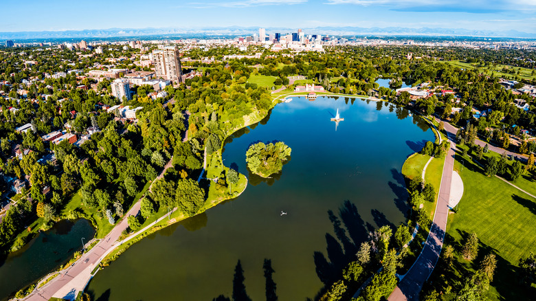 Aerial view of City Park and its lake with Denver skyline in the background