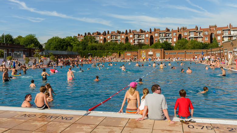 People swimming on a hot sunny summer day in Parliament Hill Lido in Hampstead