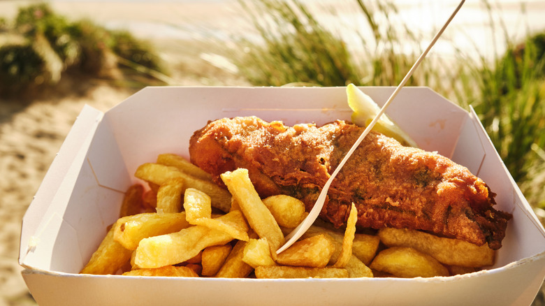 A box of fish and chips at Fistral Beach, Newquay, Cornwall