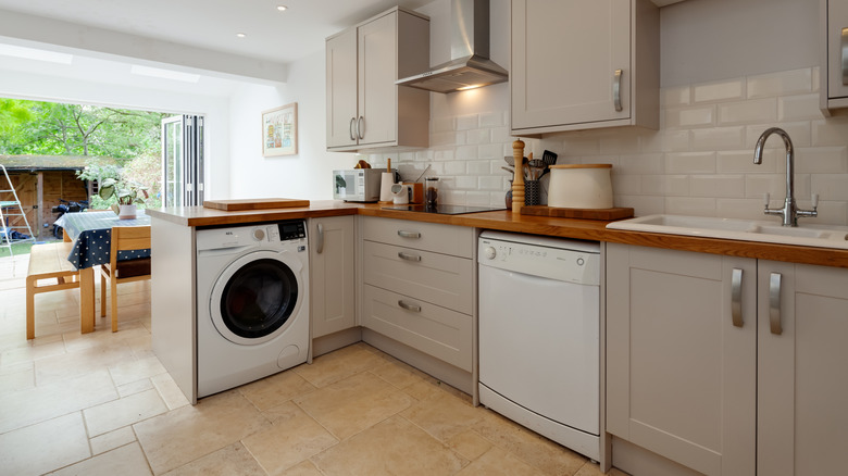 A refitted kitchen in a Victorian home in Cambridge, England, with a washing machine under the counter