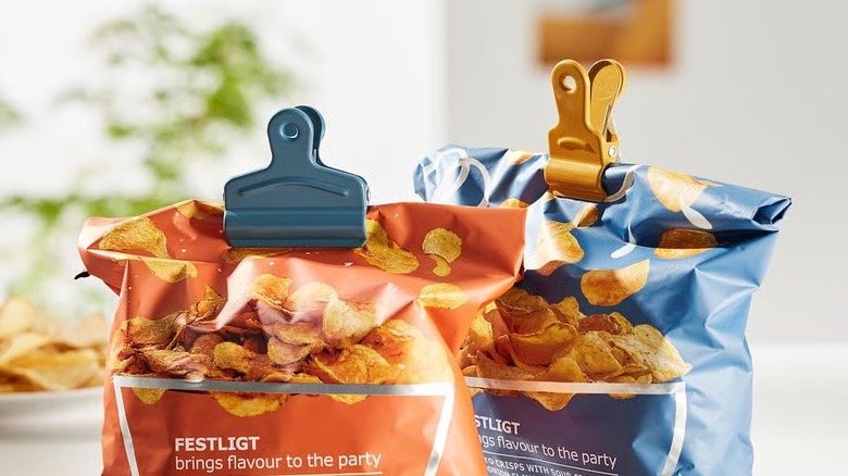 Two bags of chips held closed with metal sealing clips