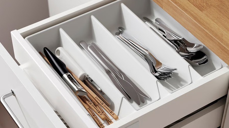 A drawer with a divider in it, which holds flatware