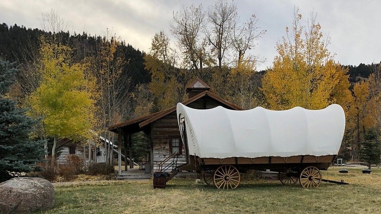 The cabins and a covered wagon at The Ranch At Rock Creek in Philipsburg, Montana