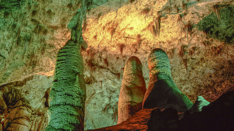 lights illuminating stalamite and stalactite formations