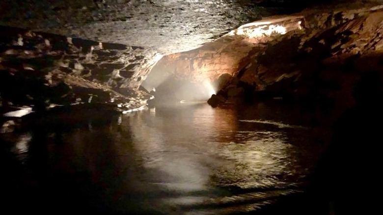 water flowing inside an illuminated cave