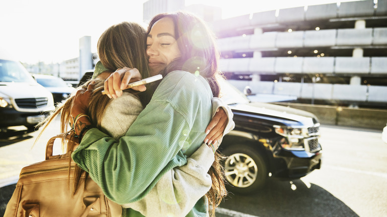 Family hugging at airport