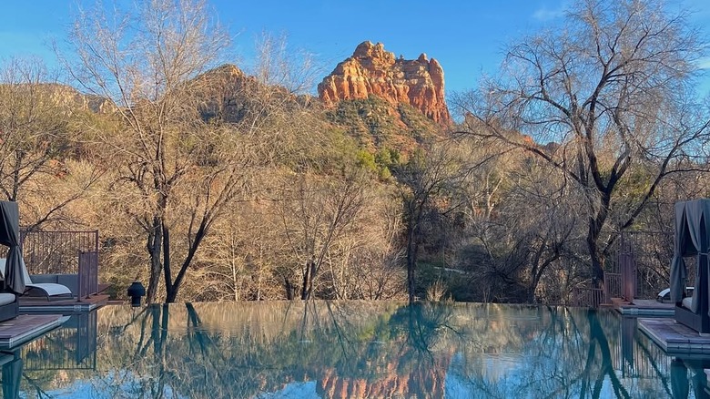 Infinity pool with red rocks in background at Amara Resort and Spa