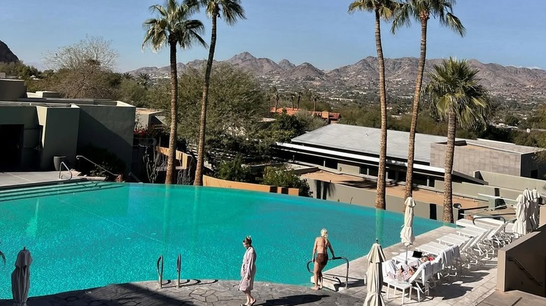 Pool with palm trees and mountain scenery at Sanctuary Camelback Mountain Resort