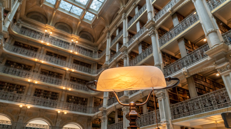 Ornate light set against the many balconies of the George Peabody Library in Maryland