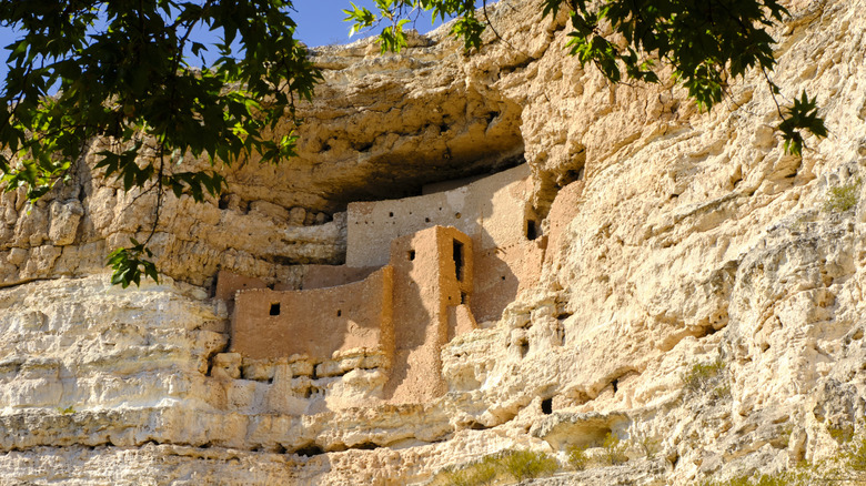 Montezuma Castle built into a cliff of red stone in Arizona