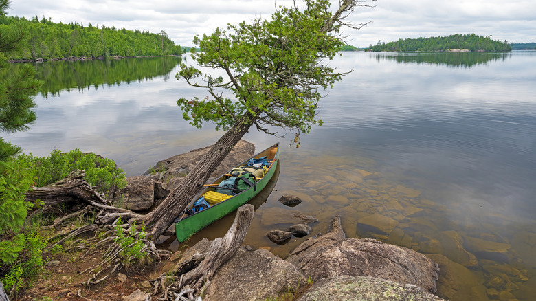 A heavily packed canoe on the shore of a lake in the Boundary Waters Wilderness Canoe Area