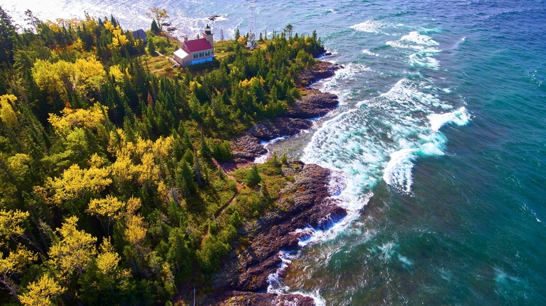 Aerial view of a Michigan lighthouse on the shores of Lake Superior during the fall