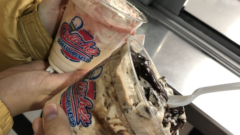 Two young women holding frozen custard desserts from Caliche's Frozen Custard in Las Cruces, NM.