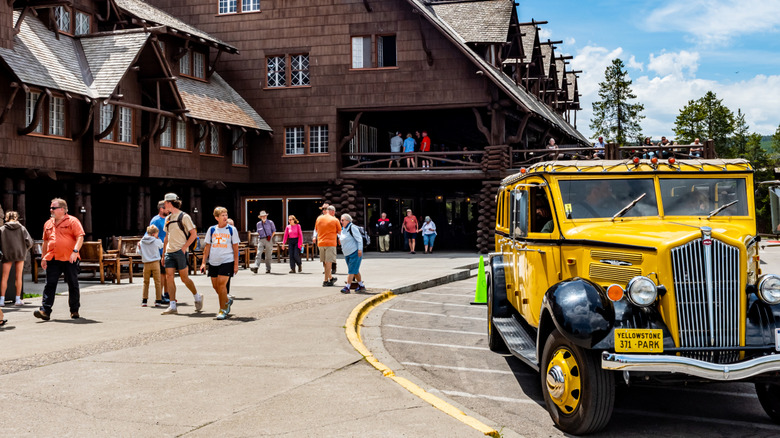 Tourists are visiting Old Faithful Inn at Old Faithful Geyser, Yellowstone National Park