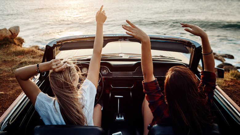 Two happy young women enjoying a summer's road trip together