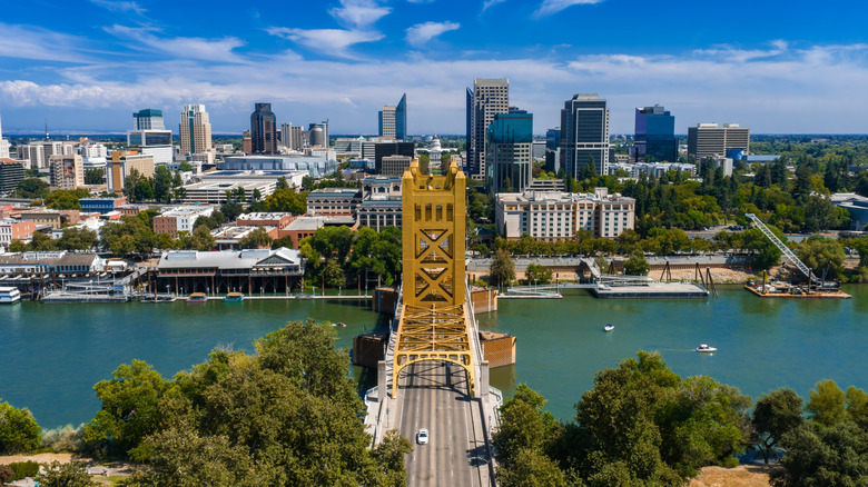 Aerial view of Sacramento, California, featuring the golden Tower Bridge over the Sacramento River