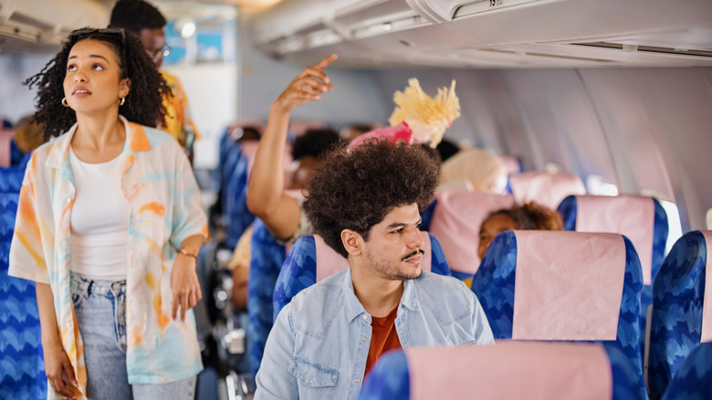 People walking in the airplane cabin