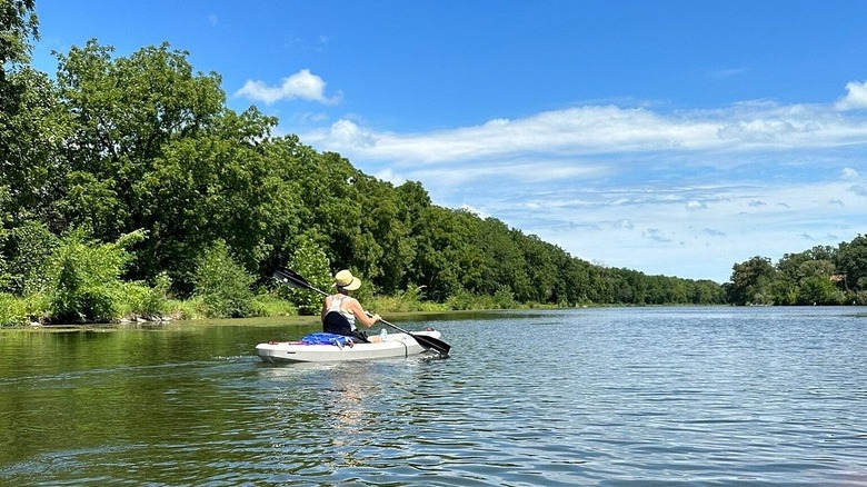 A kayaker paddles down a river at Geneseo Campground, Geneseo, Illinois
