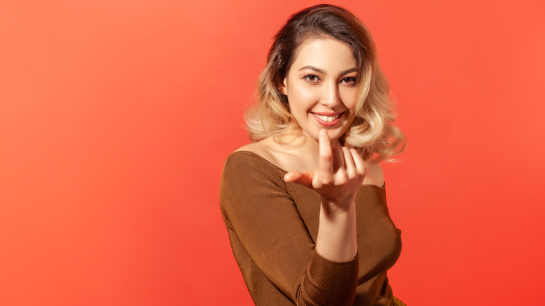 woman beckoning with finger