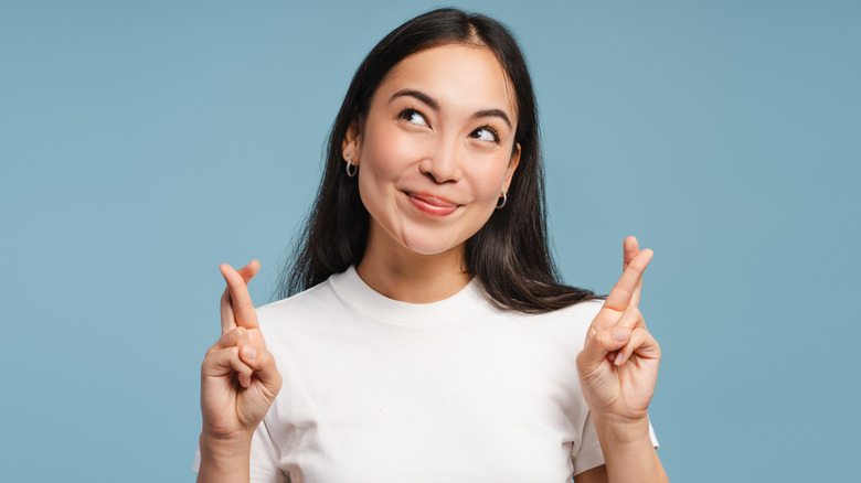 woman crossing fingers for luck