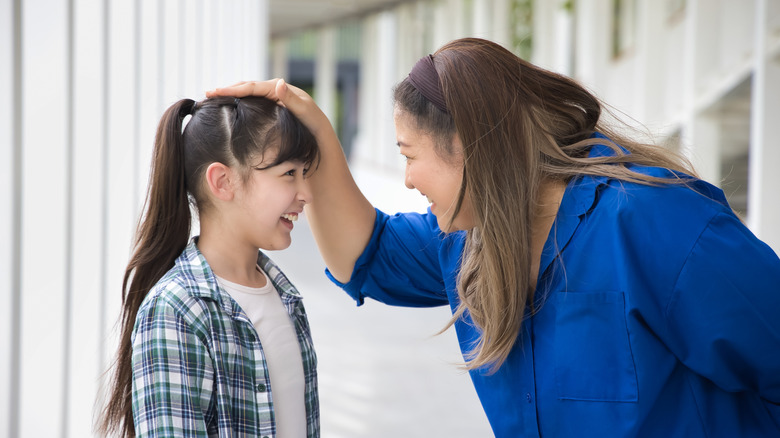 woman touching kids head