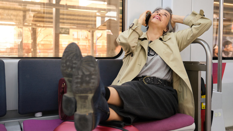woman with feet up on train
