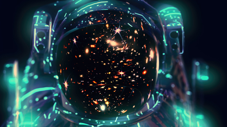 An astronaut helmet reflecting stars