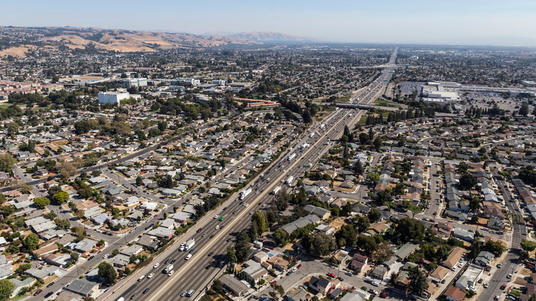 Aerial view of streets, buildings and traffic along the 880 freeway near Hayward, San Leandro and Oakland, California.