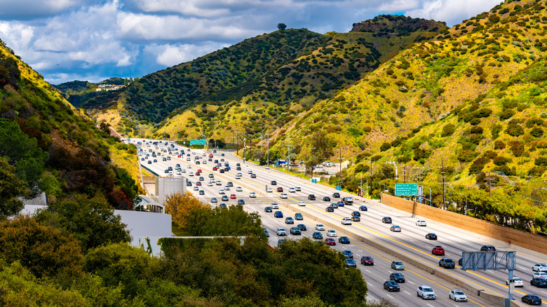 The 405 freeway running through rolling hills on a sunny day