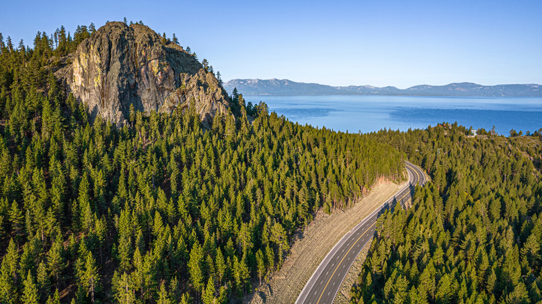 Lake Tahoe Sunrise in Summer with road winding through the mountains