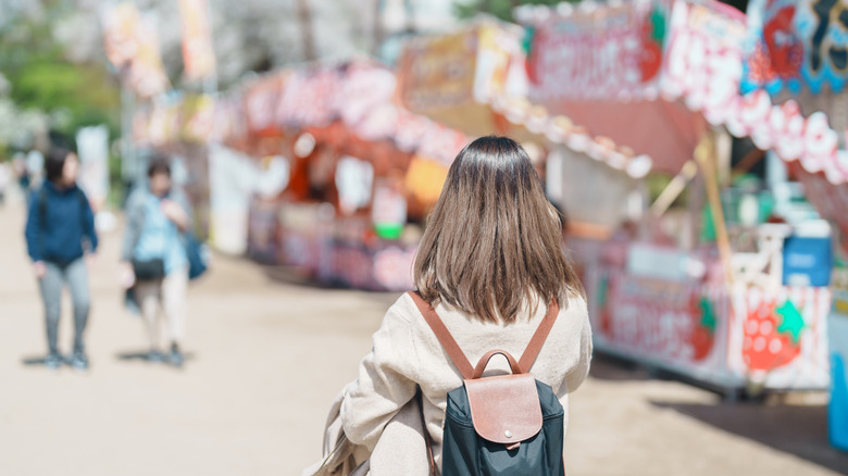 Tourist walking through a festival market in Japan