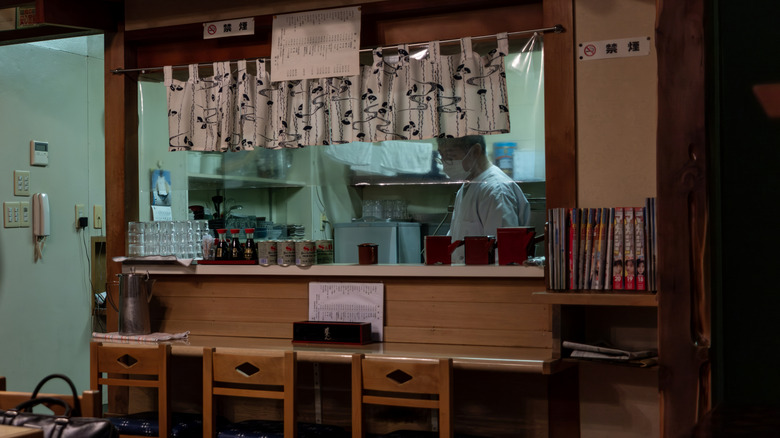 View of counter at a tiny tempura and soba restaurant in Japan