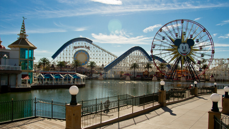 The iconic Disneyland ferris wheel and waterfront at Disney California Adventure Park's Pixar Pier