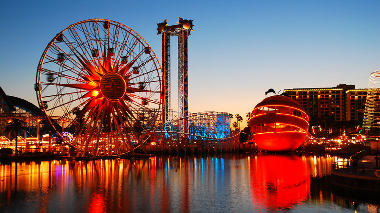 Sunset over the neon lights and rides at Pixar Pier in Disneyland, Anaheim.