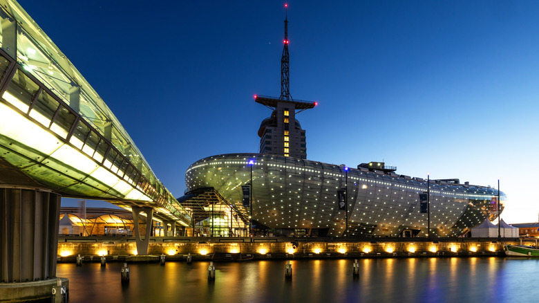 Exterior view of the Klimahaus science center, lit up at night, in downtown Bremerhaven, Germany