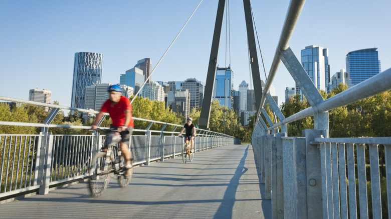 The Calgary, Alberta skyline seen from a bridge with cyclists