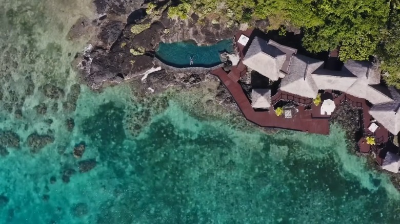 A pool and buildings on the water at COMO Laucala Island, Fiji