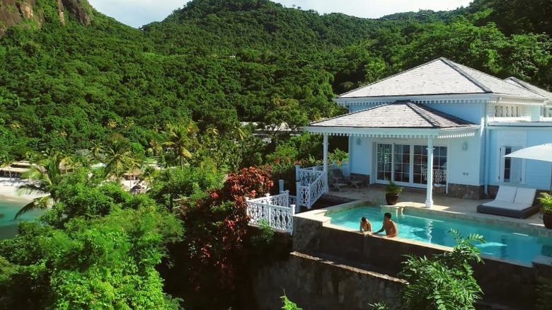 A couple in a private pool surrounded by nature at Sugar Beach