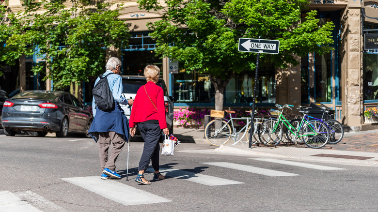 Two seniors walk through Aspen, Colorado
