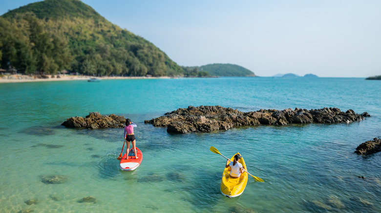 Women paddleboarding in Thailand