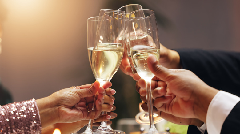 A group clinking with champagne