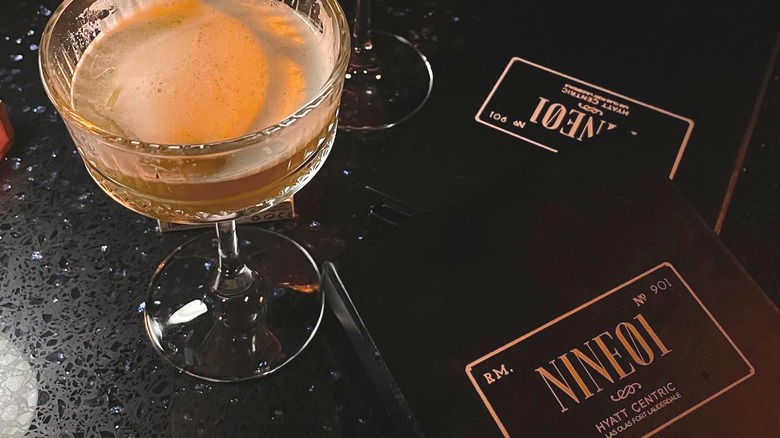 A drink with the Rm. Nine01 menu next to it