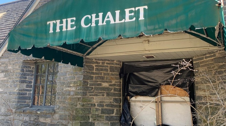 Green awning with The Chalet on it and boarded up door Camp Tamiment
