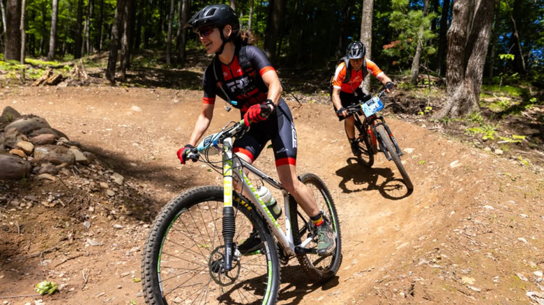 Two mountain bikers navigate a curve on Mt. Telemark