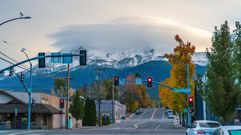 A volcano covered in snow seen from the streets of Mt. Shasta