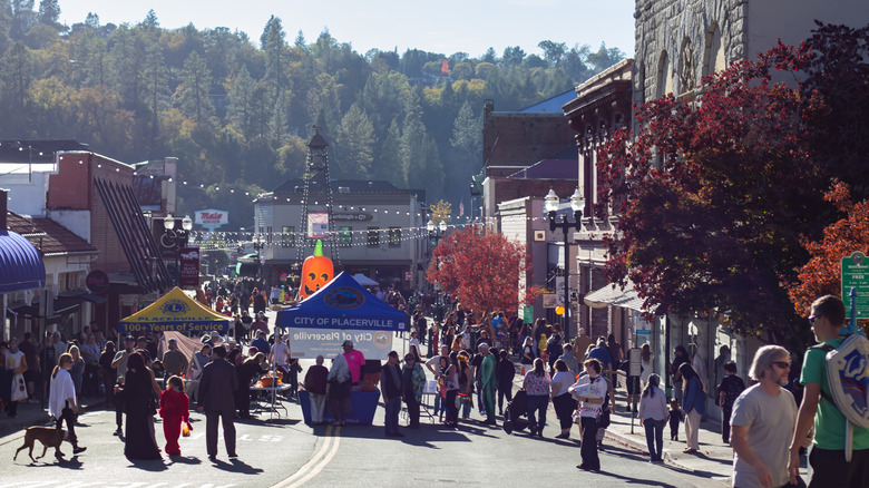 People gather at an event on a street in Placerville, CA