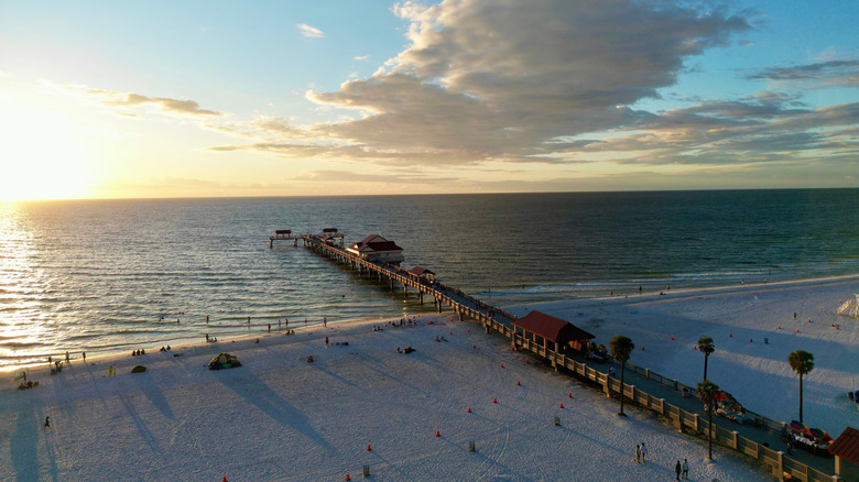 pier extending out into the water on the beach